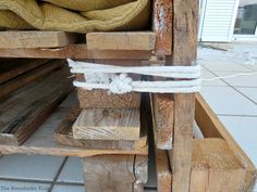 a pile of wood sitting on top of a tiled floor