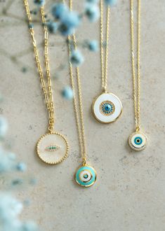 Add mystique to your necklace layering collection by wearing our unique Sehr Necklace. Rich enameled detail and sparkling round brilliant cut nano turquoise and cubic zirconia create a mysterious evil eye in a drop medallion setting. Milgrain beaded edges around the pendant exude a vintage influence, all suspended on ring link bail and connected to a Figaro link style chain. Metal Type: 925 Sterling Silver Metal Plating: Yellow Gold PlatingGemstone: Gold Cubic ZirconiaLength: 16-18” Medallion Necklace Layering, Enamel Gold Jewellery, Multi Strand Necklace Gold, Pretty Ornaments, Enameled Jewelry, Evil Eye Necklace Gold, Trend Jewelry, Jewelry Accessories Ideas, Necklace Layering