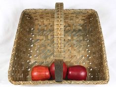 two apples in a basket on a white background