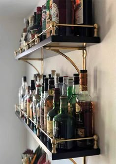 several shelves filled with different types of liquors and bottles on top of each shelf