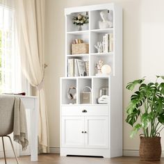 a white bookcase with doors and drawers in a living room