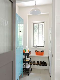 a white hallway with blue doors and shoes on the floor