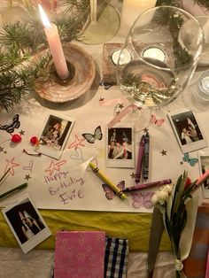 a table topped with pictures and candles