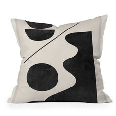 a black and white pillow with an abstract design