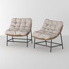 two chairs sitting next to each other on a white surface