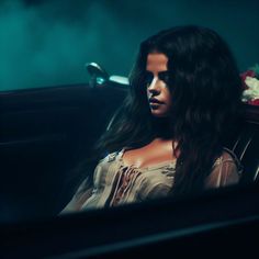 a woman sitting in the back seat of a car