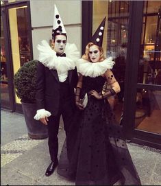 two people dressed in costumes standing next to each other