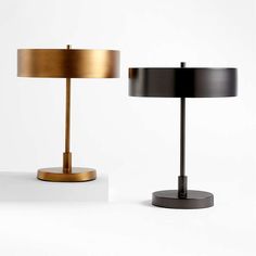 two lamps sitting next to each other on a white surface