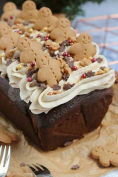 a chocolate cake with white frosting and gingerbread cut out of it's sides