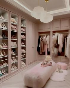 the closet is filled with lots of shoes and other items, including fur - lined foot stools