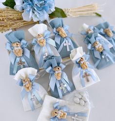 small teddy bears in blue and white outfits with bows on them, sitting next to other items