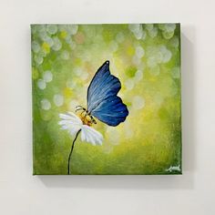 a painting of a blue butterfly on a white flower in front of a green background