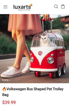 a woman is pulling a red and white vw bus with a cat in it