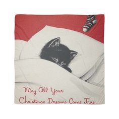 a black and white cat laying on top of a bed under a blanket with the words, may all your christmas dreams come true