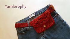 a pair of blue jeans with a red knitted belt attached to the back of it