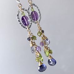 "7321 These gorgeous long cluster dangle drop earrings were meticulously handcrafted with natural gemstones, mix metal - gold filled and sterling silver components. While offering bold and stylish look, they are great for everyday wear or some special occasions. These earrings will make perfect birthday, anniversary, appreciation or holiday gift for yourself or special woman in your life - mom, wife, girlfriend, daughter, sister, grandma, niece, aunt, cousin, best friend, teacher, coach, doctor, caregiver or colleague.  MATERIALS & DIMENSIONS ✦ Natural multi gemstones of various shapes and colours - IOLITE, PERIDOT, AMETHYST ; ✦ GOLD FILLED wire wrap, fine chain and jump rings; ✦ STERLING SILVER textured oval links and lever back (shown) or fish hook ear wires; ✦ Total length of shown earr Cousin Best Friend, Cluster Jewelry, Bead Drop Earrings, Rings Sterling Silver, Amethyst Gold, Boho Luxe, Beaded Drop Earrings, Bohemian Earrings, Fine Earrings