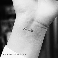 a small wrist tattoo with the word faith on it