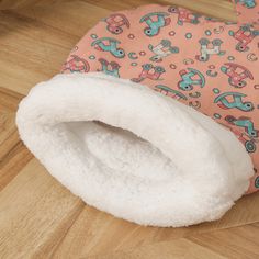 a baby bib laying on top of a wooden floor