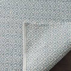 a close up view of a blue and white rug