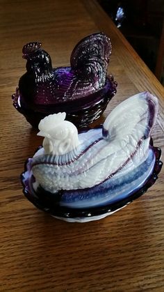 two glass dishes sitting on top of a wooden table