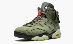 The Travis Scott x Air Jordan 6 marks the third time the world famous rapper and Jordan Brand have partnered on an Air Jordan. Scott revisits earth tones as the central theme of the “Cactus Jack” Air Jordan 6, just as he did with his first collaboration on both the high and low top Air Jordan 1 models. The upper part of the sneaker is comprised of an olive-based nubuck material with black detailing and contrasting red accents. An added stash pouch on the collar is reminiscent of the kinds of poc Air Jordan 6 Travis Scott, Jordan 6 Travis Scott, Nike Travis Scott, Rapper Travis Scott, All Jordans, Retro 6, Air Jordan 6 Retro, Nike Air Jordan 6, Jordan 6 Retro