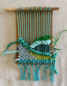 a weaving machine with several different colored yarns on it