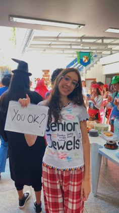 a girl in pajamas holding up a sign