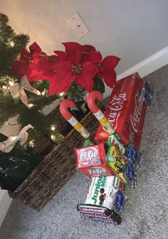 a christmas tree with candy, candies and an umbrella in front of it on the floor