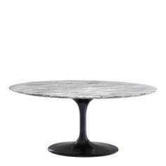 an oval marble table with black legs and a round base, against a white background