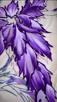 purple flowers with green stems on a white sheet