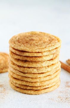 a stack of cookies sitting next to cinnamon sticks