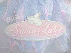 there is a swan lake sign on the back of a stuffed animal toy in this photo