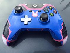 a close up of a blue and pink controller