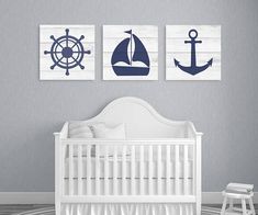 a baby's room with two paintings on the wall and a white crib