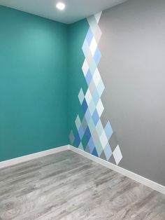 an empty room with blue and grey walls