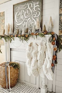 christmas stockings hanging from a mantel in front of a fireplace