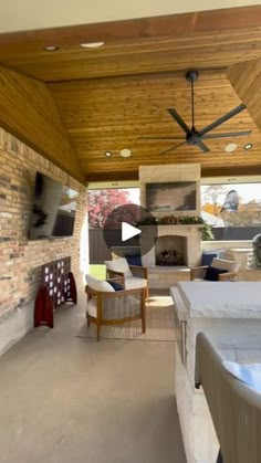 an outdoor living room with fireplace and tv