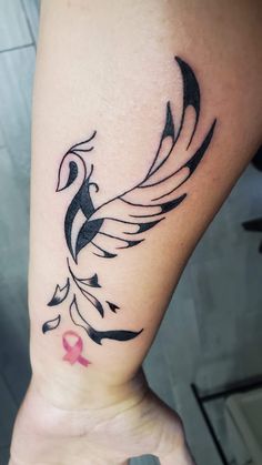 a woman's foot with a tattoo on it and a pink ribbon around the ankle