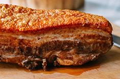 a piece of meat sitting on top of a wooden cutting board