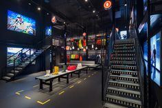 the inside of a sports shop with benches and lights hanging from the ceiling above them