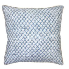 a blue and white pillow with an intricate design on the front, sitting on a white background