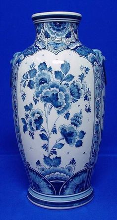 a blue and white vase with flowers on it