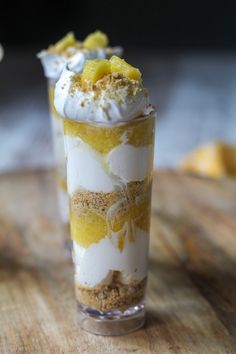 a dessert in a glass on top of a wooden table