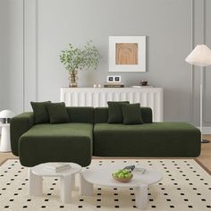 a living room with a green couch and white coffee table