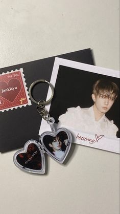 two heart shaped keychains with photos on them