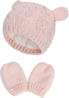 a pink knitted hat and mitten set with ears on the front, one in white