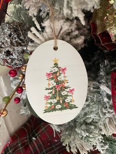 a christmas tree ornament hanging from the side of a fir tree