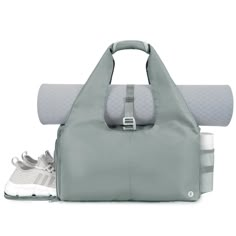 a gray bag and some white shoes