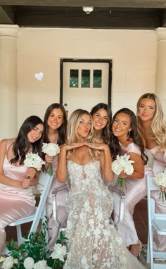 the bridesmaids pose for a photo in their pink dresses