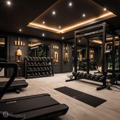 a gym with treadmills, exercise equipment and mirrors in the background at night